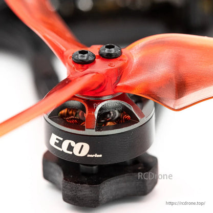 Close-up of ECO series brushless motor with orange propeller hub and mounting screws