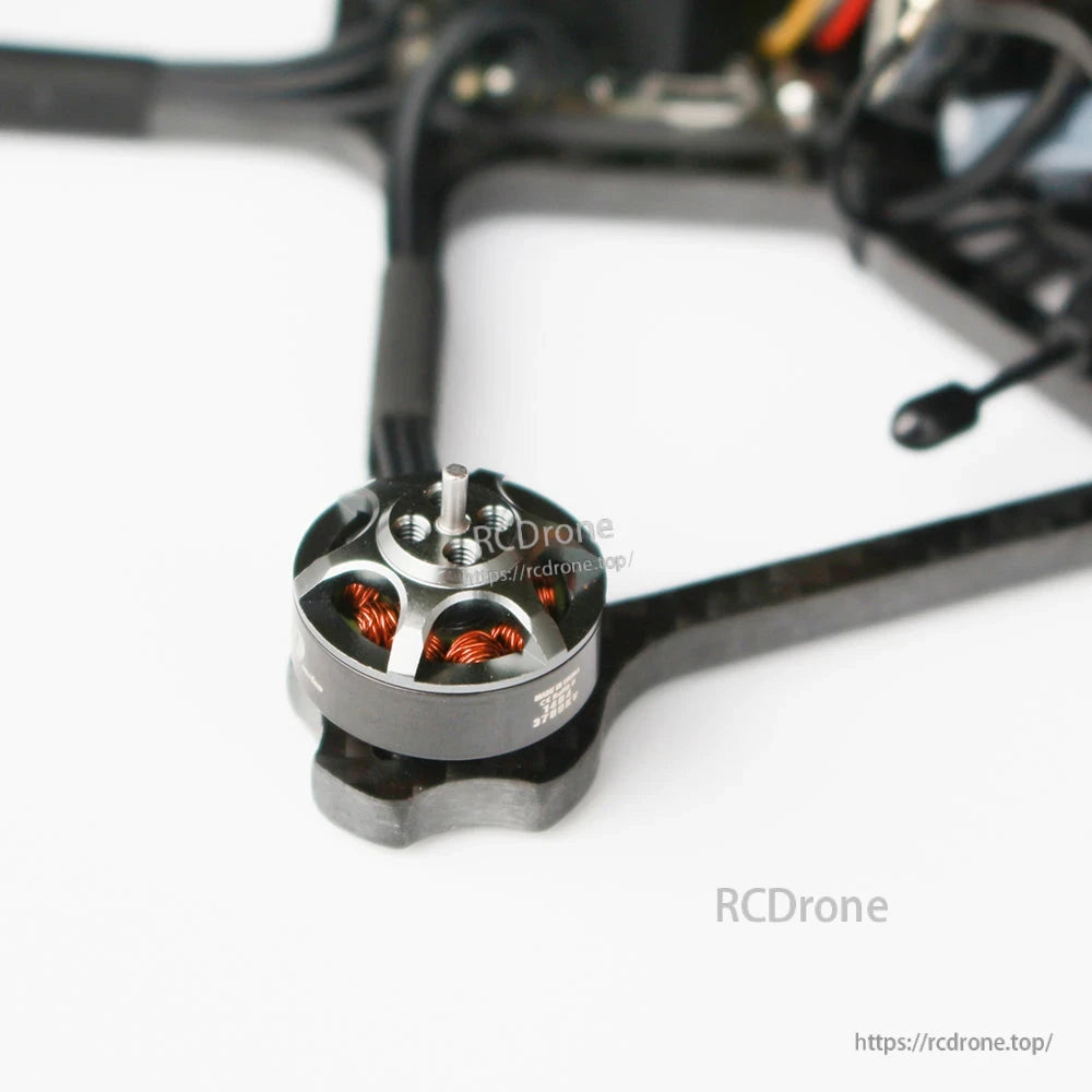 Close-up of brushless motor on carbon fiber arm showing stator windings and mounting