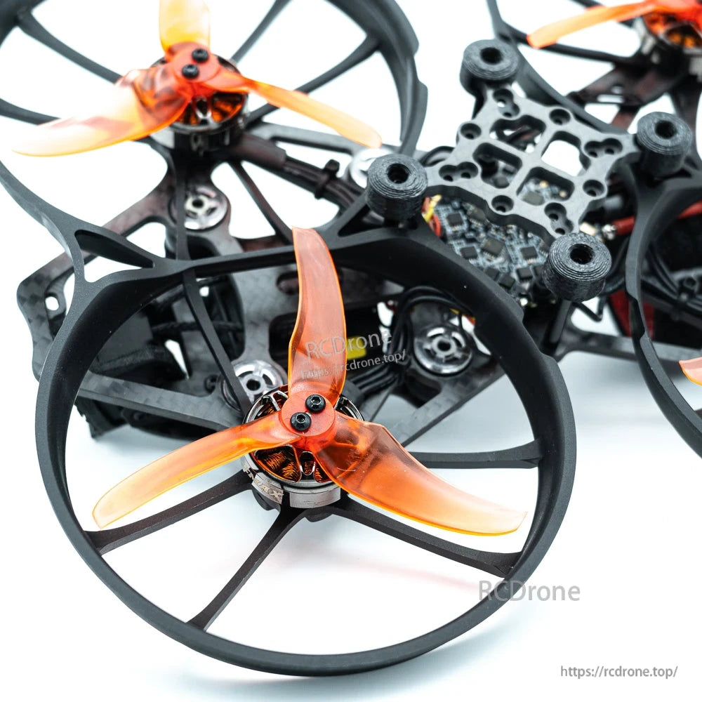 Close-up of orange tri-blade propellers and motors inside circular duct guards