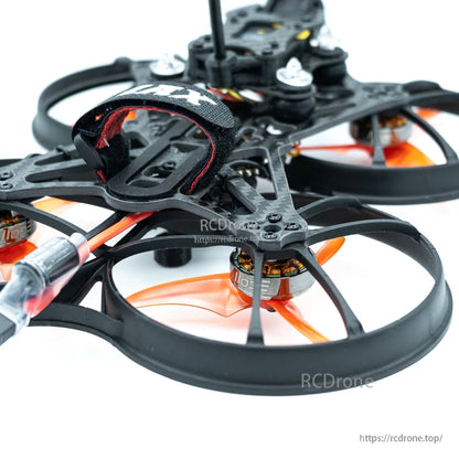 Close-up of battery strap mount area and front prop duct with orange tri-blade prop