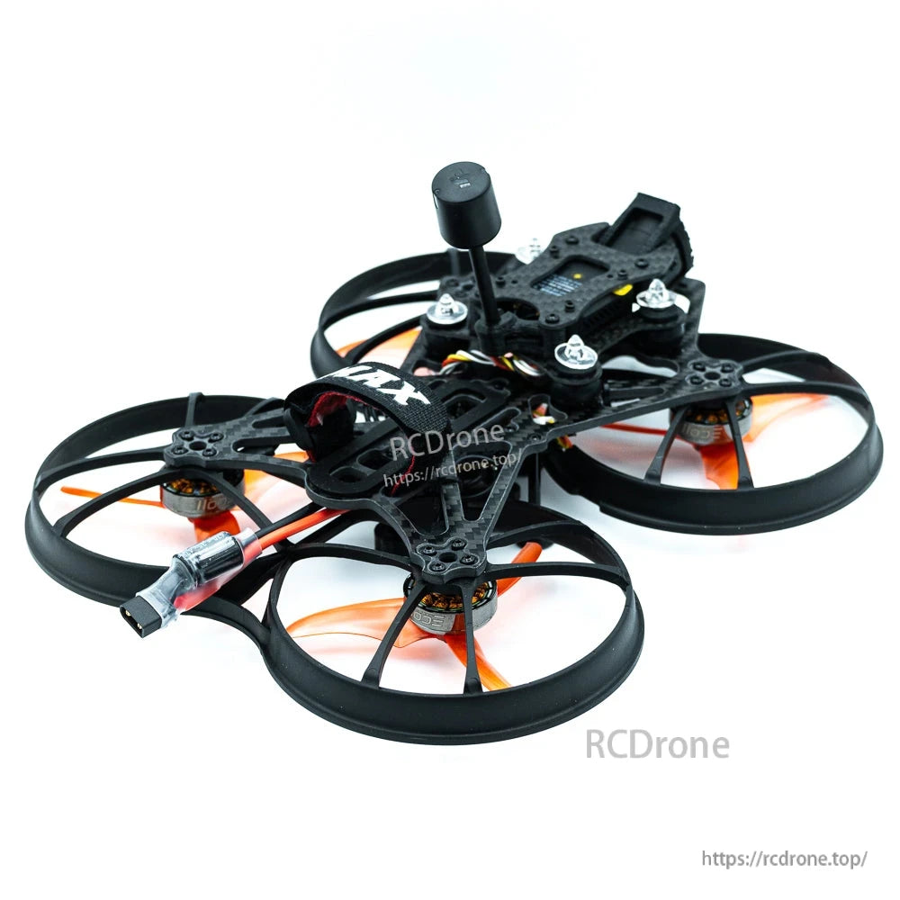 Low side view of cinewhoop drone showing prop ducts, standoffs, and rear power lead