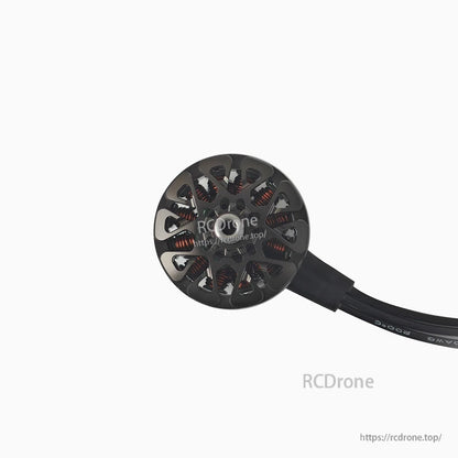 Straight top view of motor with vented bell and attached wire lead on white background