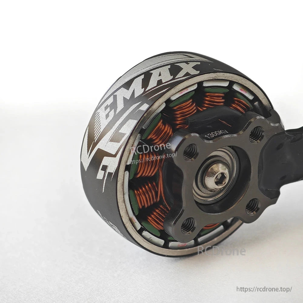 Close-up of motor base showing copper windings, bearing center, and mounting holes