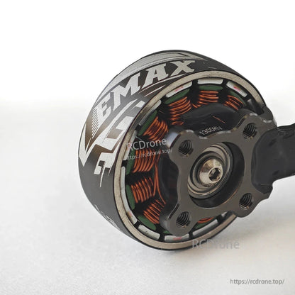 Close-up of motor base showing copper windings, bearing center, and mounting holes