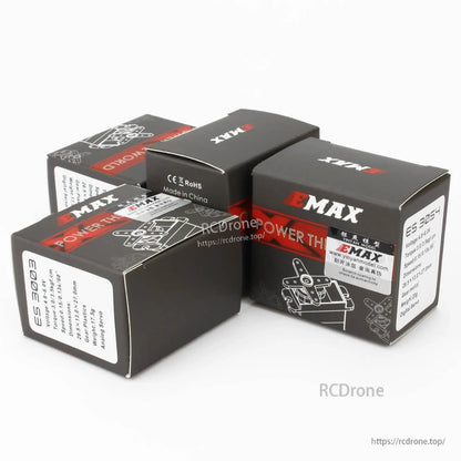 Stacked EMAX servo boxes showing ES3003 model label and EMAX “Power the World” design