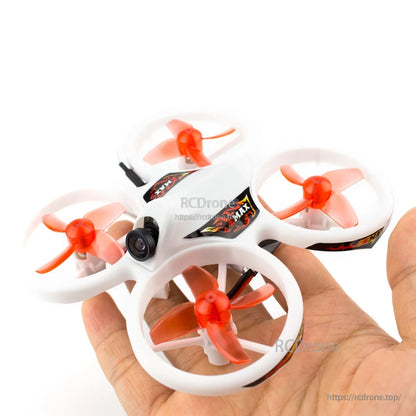 Hand-held size reference of the small ducted quadcopter with orange propellers
