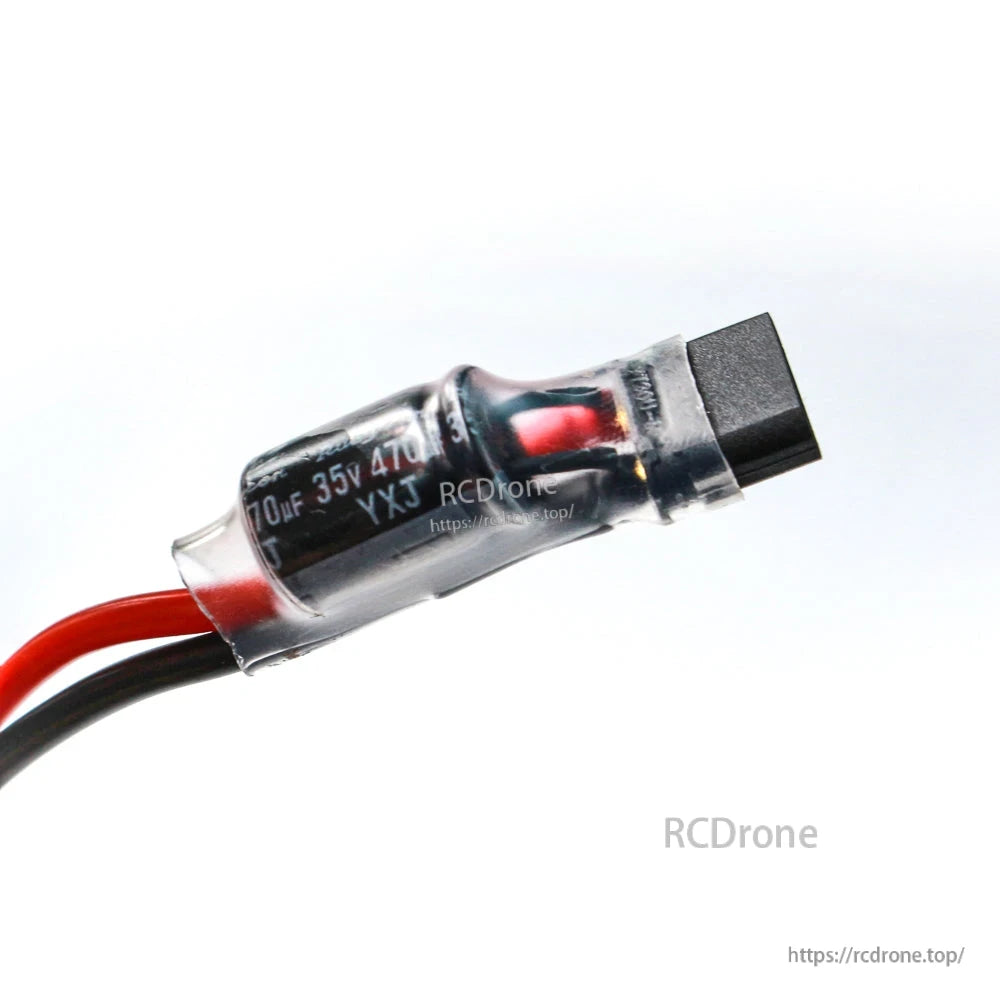 Close-up of 470uF 35V capacitor and XT30-style battery connector on power lead