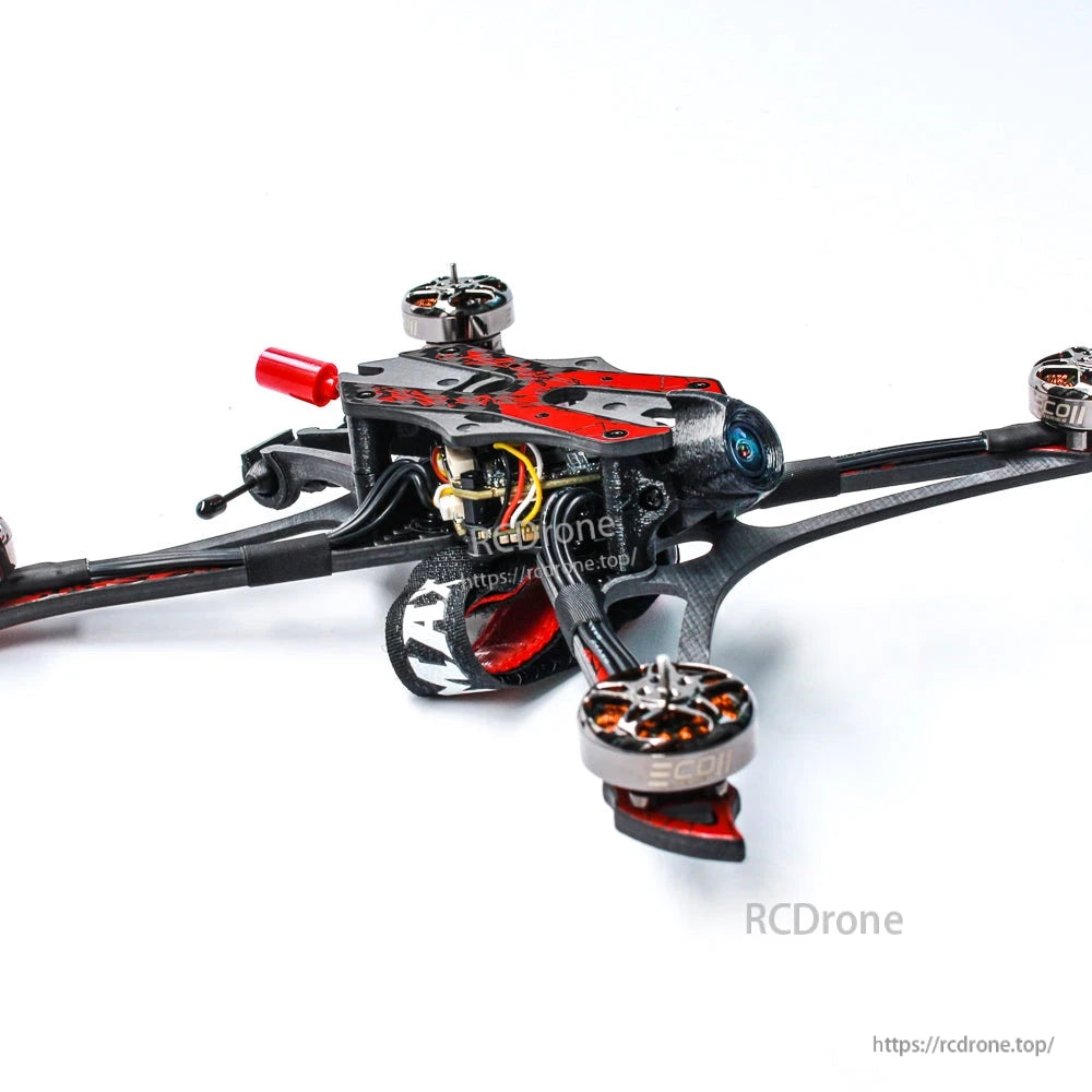 Front-left angle showing camera, battery strap, and motor layout on carbon-fiber frame