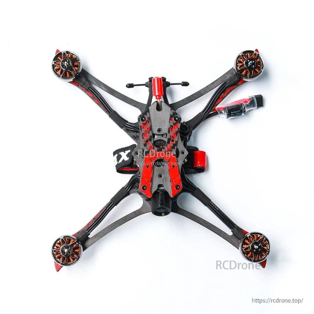 Straight top view of quadcopter frame with four motors, top plate, and battery lead to the right
