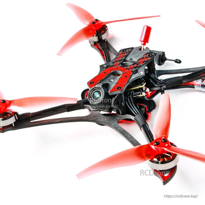 Close-up of top plate and stack area with carbon frame arms and red propellers at corners