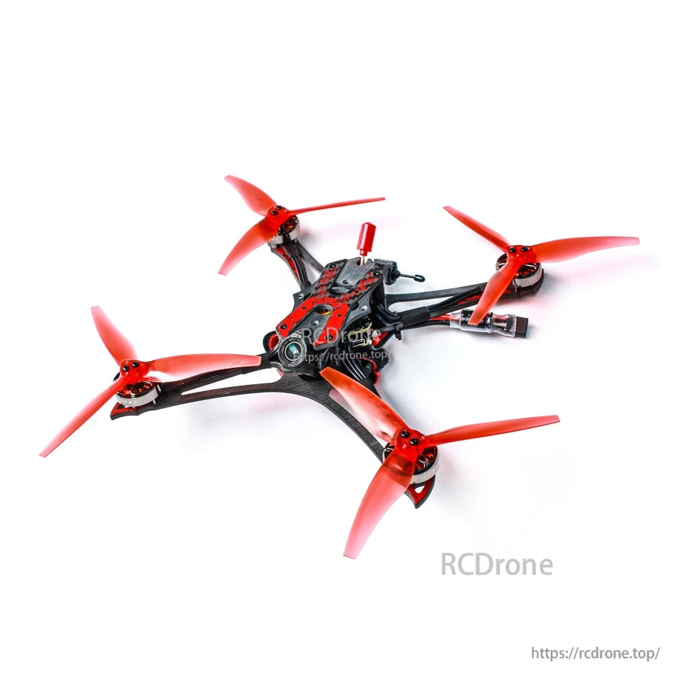 Top-down angled view of the quad frame with red props, exposed wiring, and battery lead