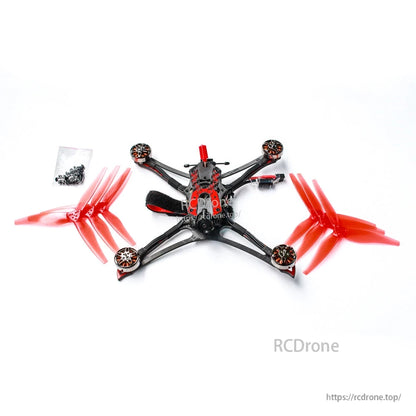 Package contents layout: quadcopter, extra red propellers, and small bag of screws