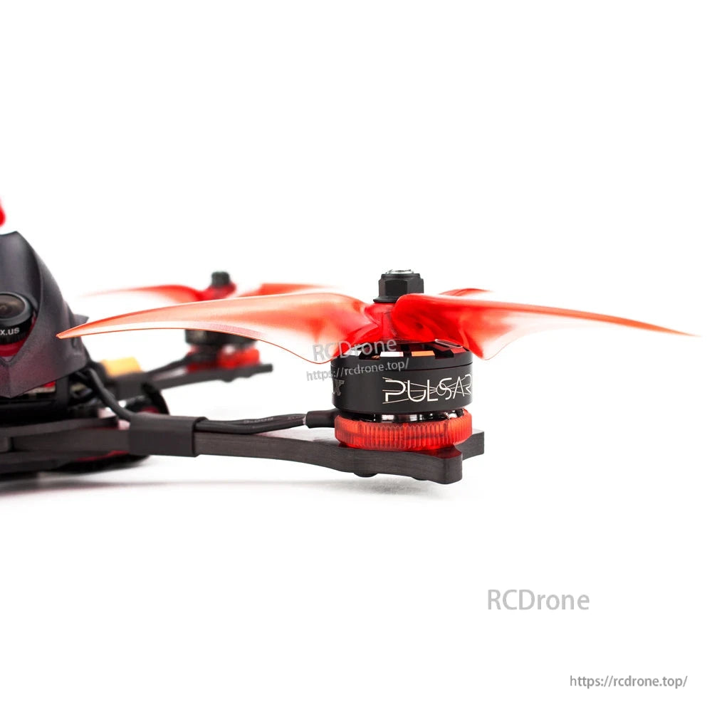 Close-up of motor and orange propeller on the Hawk Pro quad, showing arm and motor bell detail