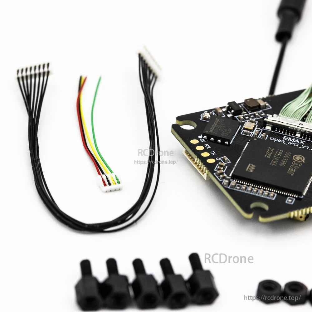 Included wiring harnesses and mounting hardware next to the VTX main board close-up