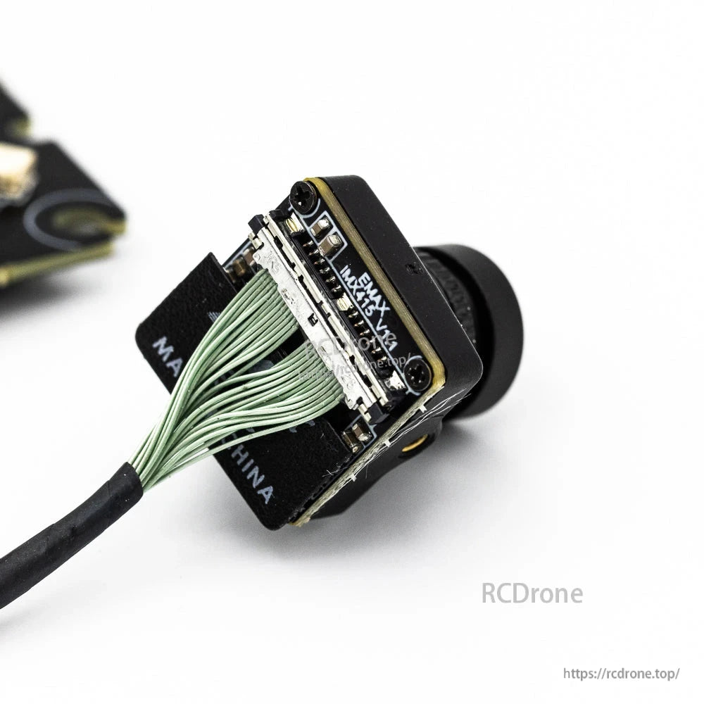 FPV camera module close-up showing ribbon connector and mounting bracket