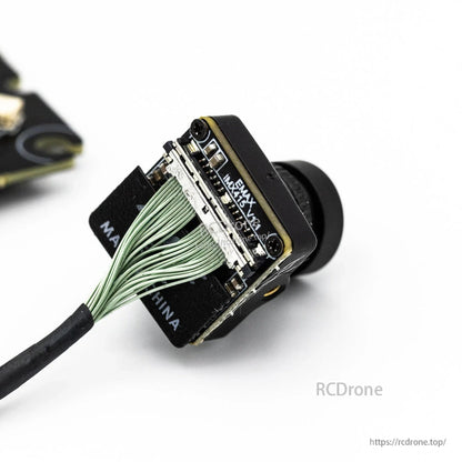 FPV camera module close-up showing ribbon connector and mounting bracket