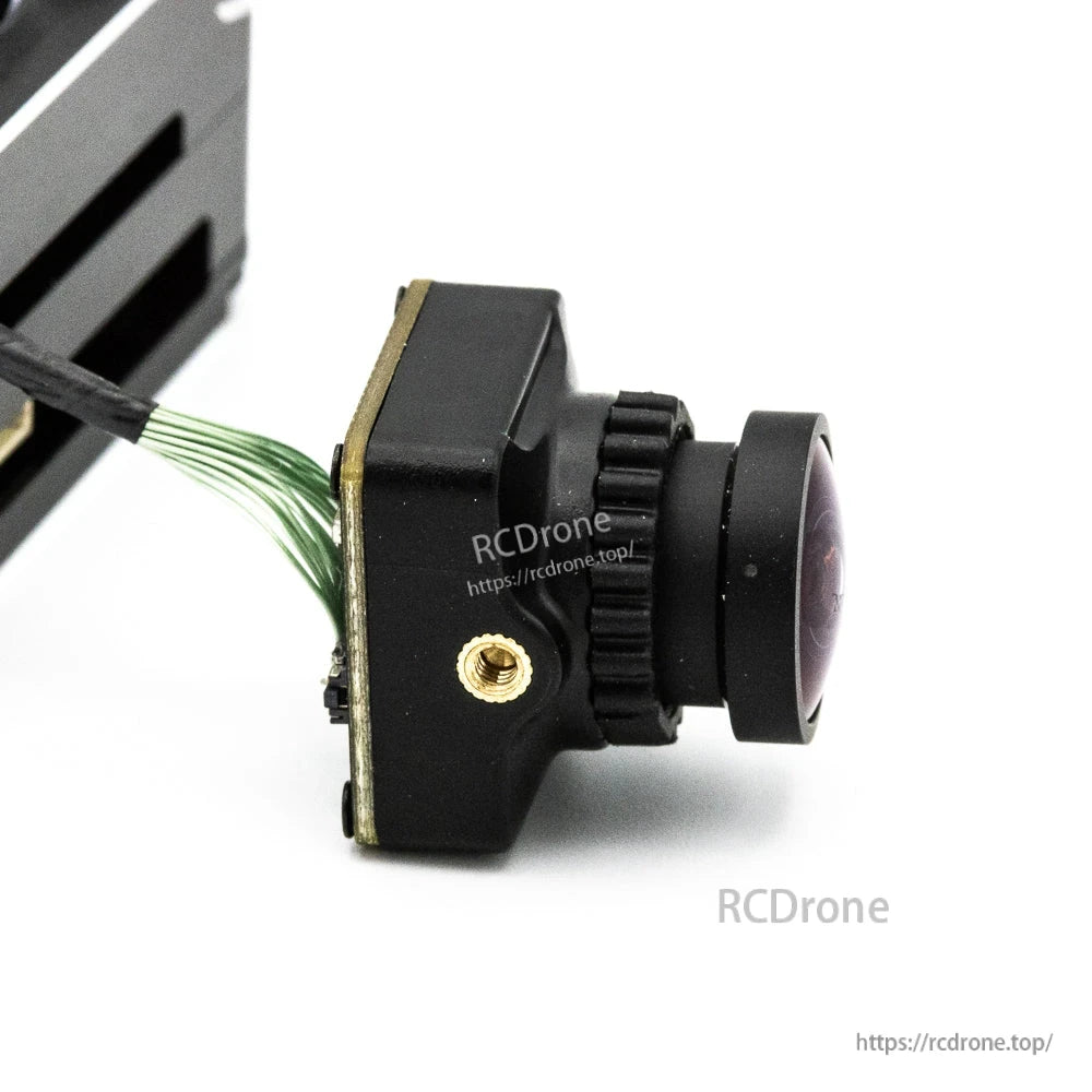 FPV camera side profile showing lens barrel, focus ring, and wiring harness exit