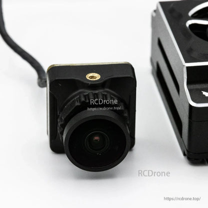 FPV camera front lens close-up from Wyvern Link kit showing square camera body and mounting point