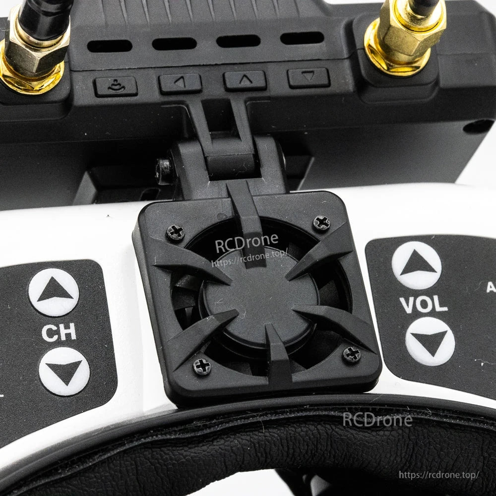 Cooling fan bracket close-up on goggles mount between CH and VOL buttons