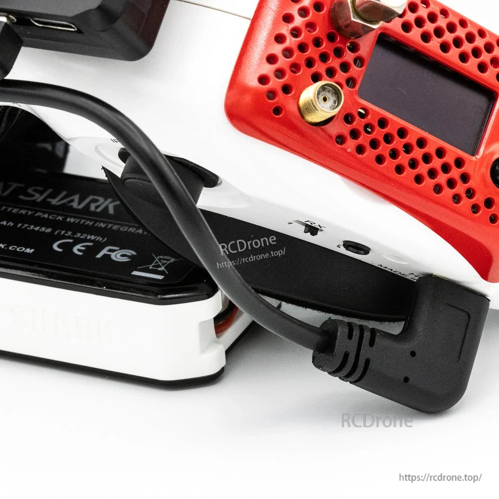 Right-angle power cable connection shown on FPV goggles and receiver setup close-up