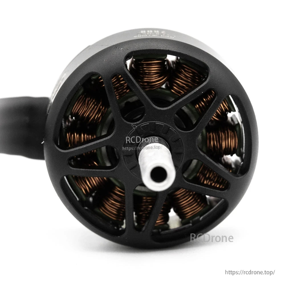 Rear angle of brushless motor showing hollow shaft opening and copper windings through the vented bell