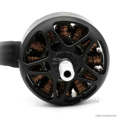 Rear angle of brushless motor showing hollow shaft opening and copper windings through the vented bell