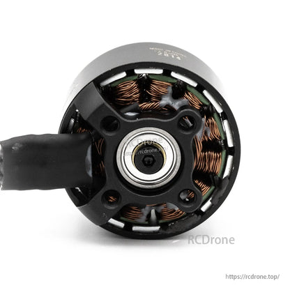 Bottom view of brushless motor showing mounting base, bearing, and bolt hole pattern