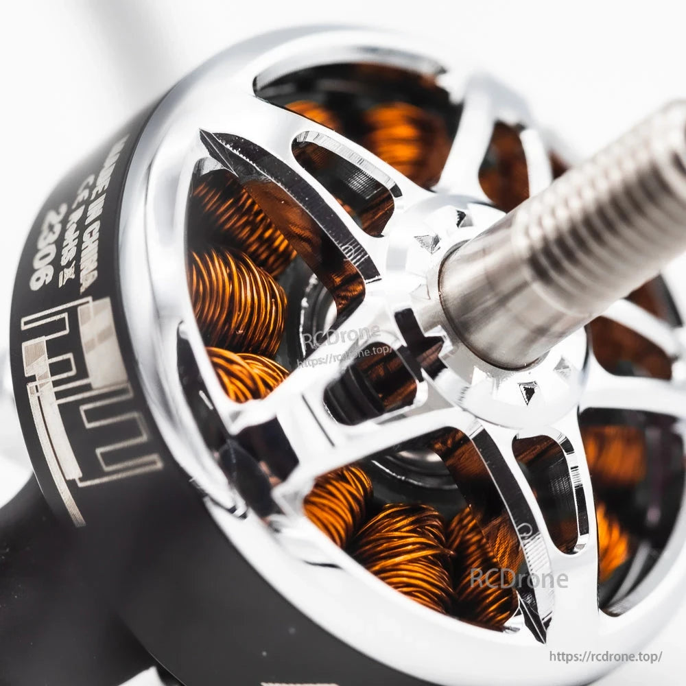 Angled close-up of motor shaft and bell, showing cutouts and copper windings inside