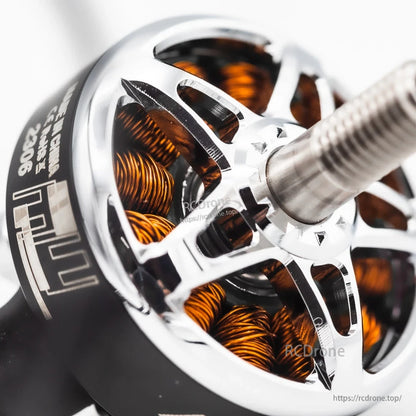 Angled close-up of motor shaft and bell, showing cutouts and copper windings inside