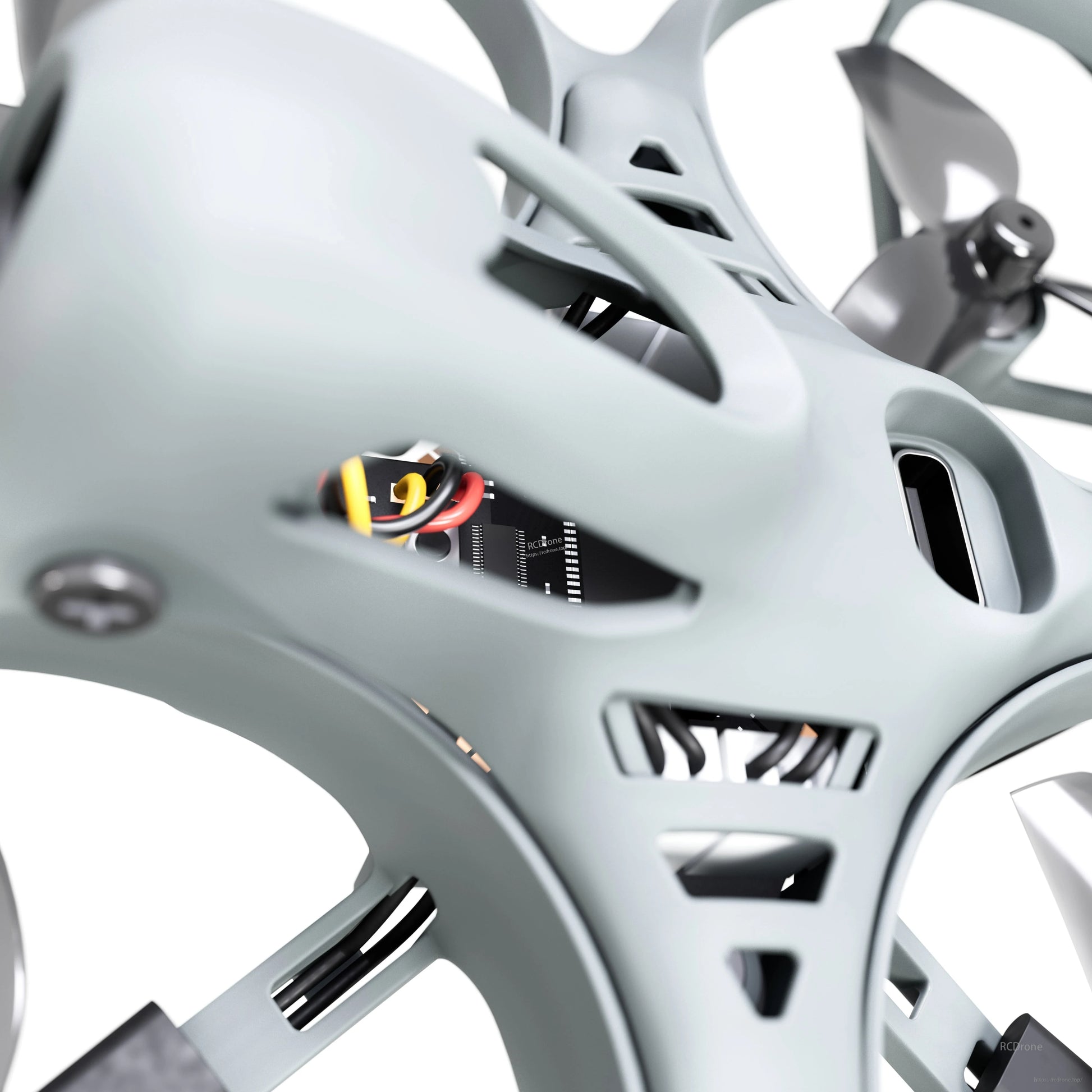 Close-up of drone canopy vents showing internal electronics and wiring through frame cutouts