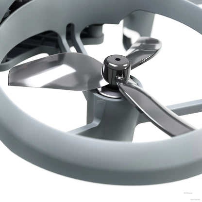 Close-up of propeller and motor inside ducted frame, showing tri-blade prop and hub