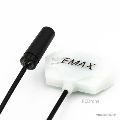 Antenna close-up with EMAX logo patch antenna and black cylindrical antenna on leads