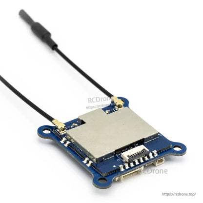 Angled view of VTX board with metal shield, dual antenna pigtails, and ribbon-style board connector