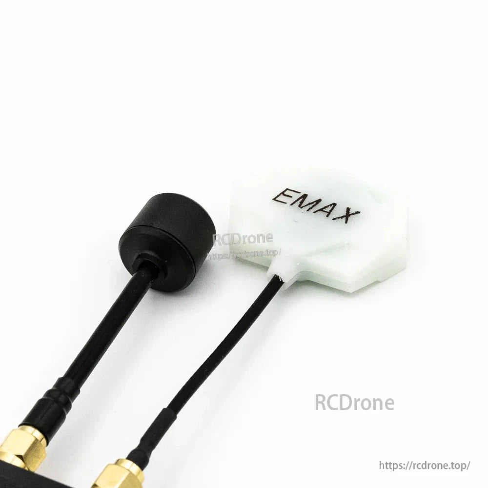 Dual antenna close-up: black stubby antenna and white EMAX patch antenna on receiver leads