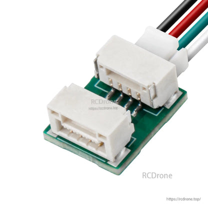 Angled view showing dual white connectors on the UART to dual PWM adapter with attached wires