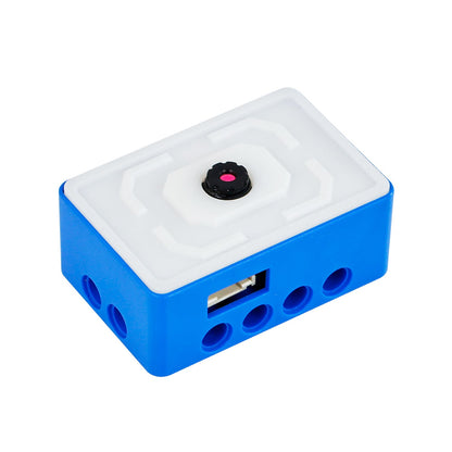 Blue camera module close-up with front lens and side connector port, LEGO-style mounting holes