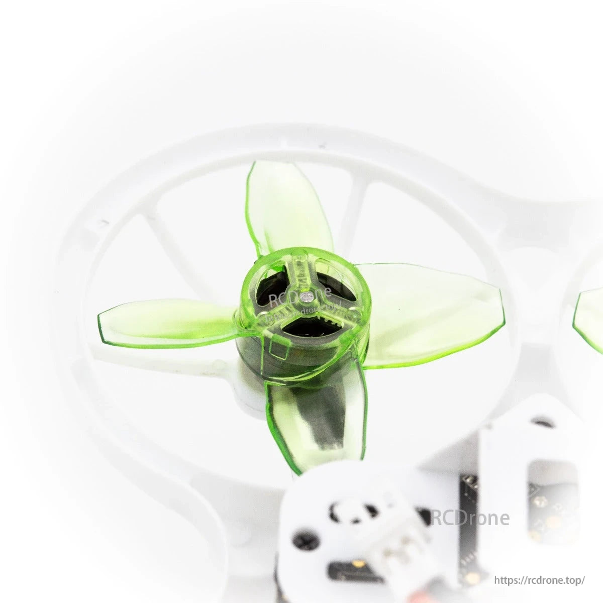 Top view of single translucent green 4-blade propeller inside white duct guard