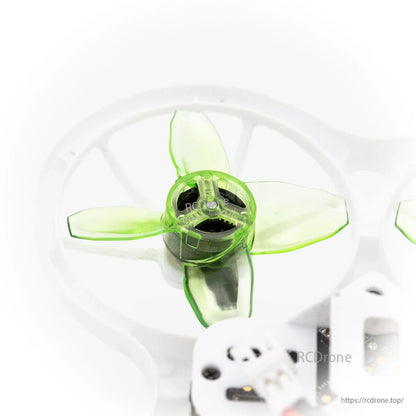 Top view of single translucent green 4-blade propeller inside white duct guard
