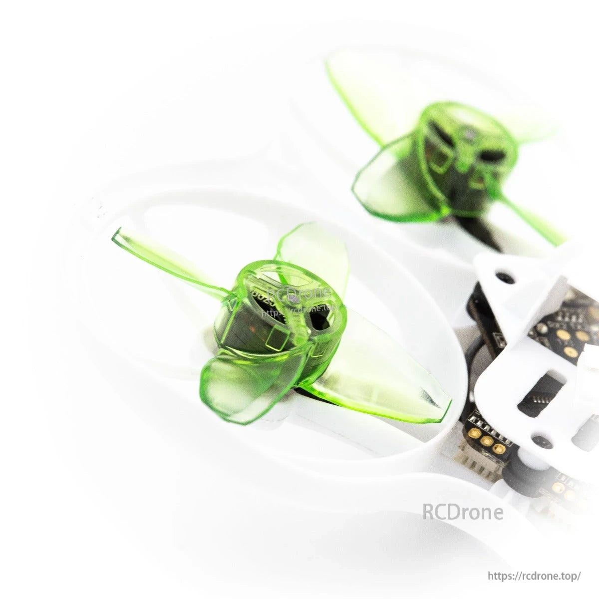 Two green 4-blade props on ducted frame, partial view of flight controller and wiring