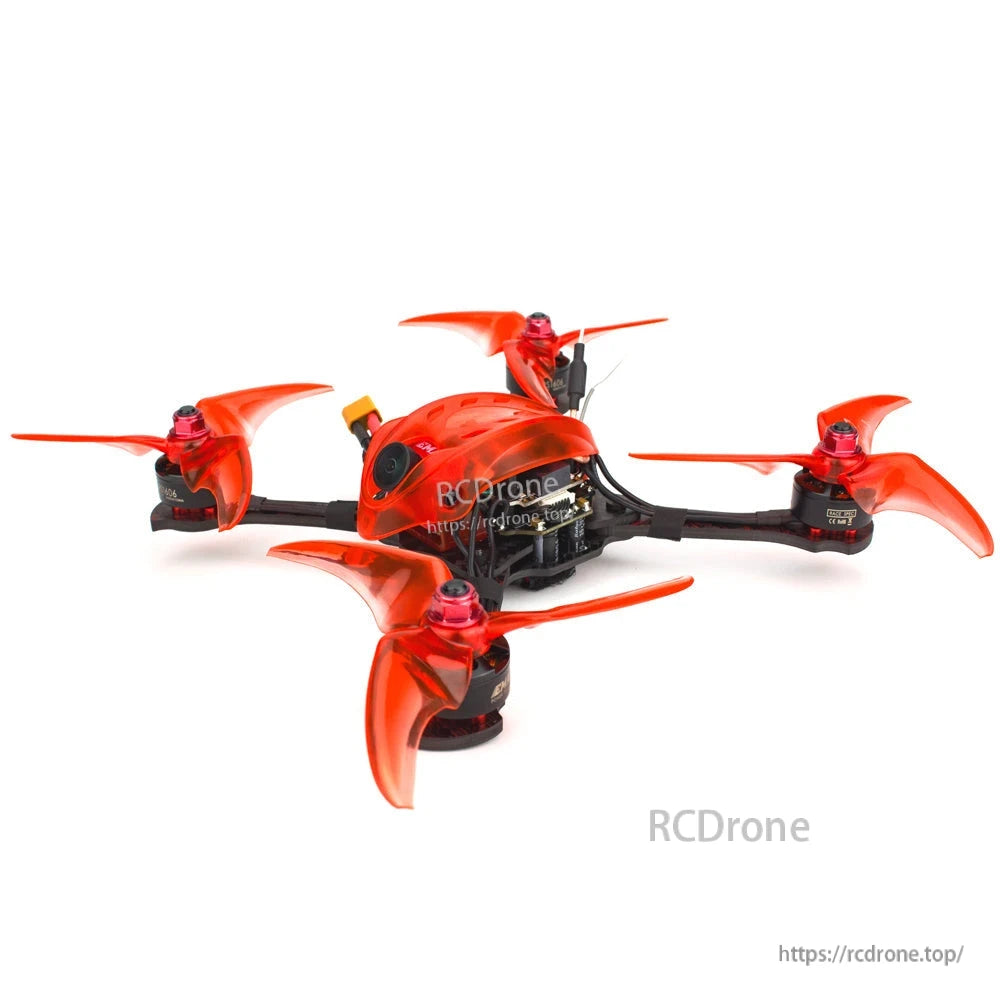 Side angle of quadcopter showing camera housing, top-mounted antenna, and low-profile carbon frame layout