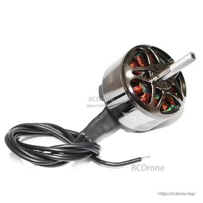 Angled top view of motor with coiled lead wires, showing vented bell design and shaft length