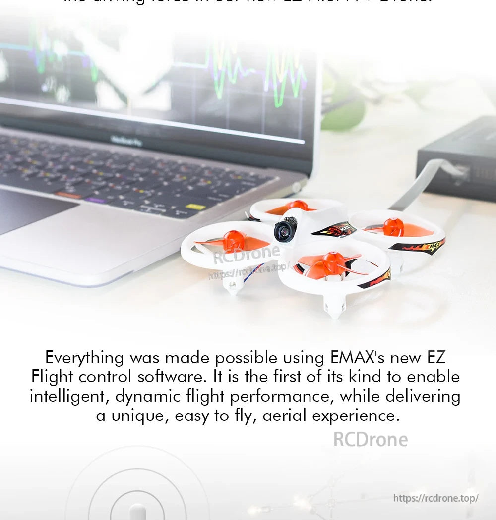 Tiny indoor FPV quadcopter on a desk, ducted prop guards and front-mounted camera for close-range practice
