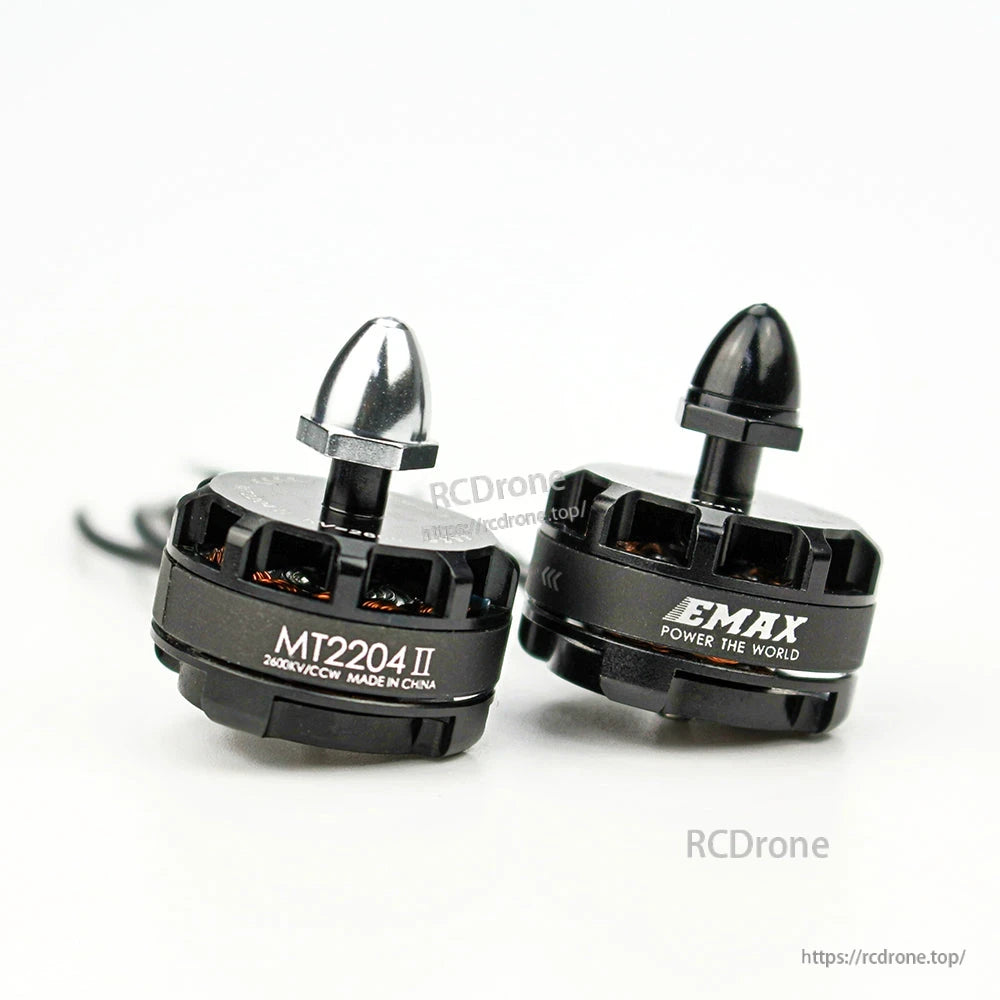 Two MT2204 II motors close-up with silver and black prop adapter nuts, side-by-side comparison view