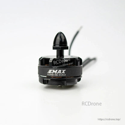 Front view of EMAX logo on motor can with installed prop nut cap, wires trailing behind