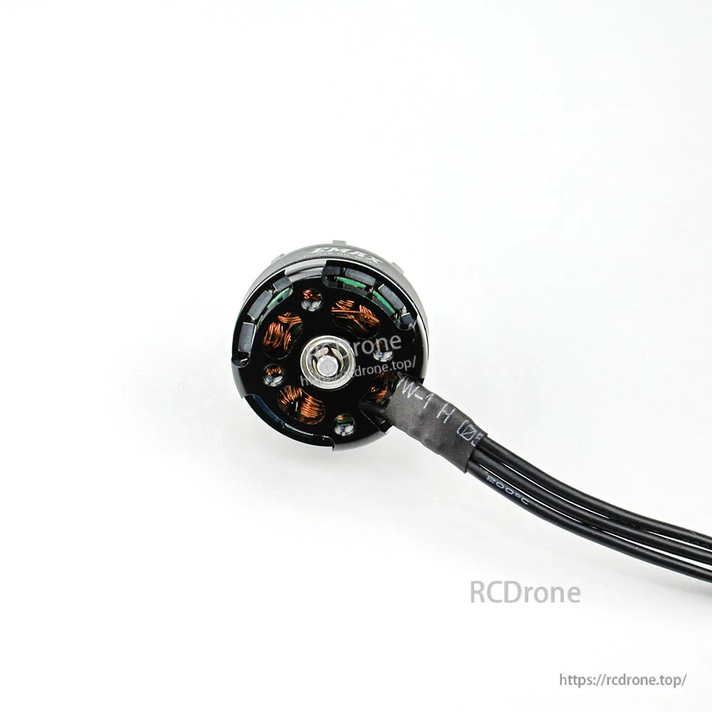 Bottom view of brushless motor showing mounting base, center screw, and internal copper windings
