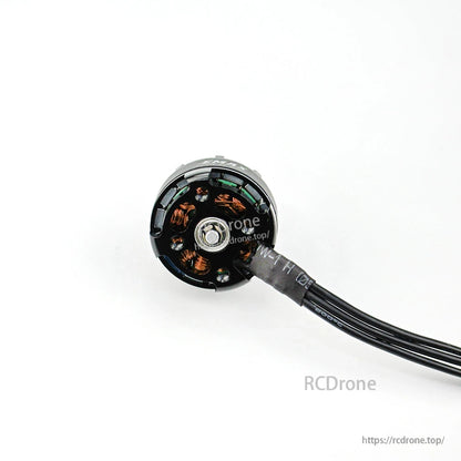 Bottom view of brushless motor showing mounting base, center screw, and internal copper windings