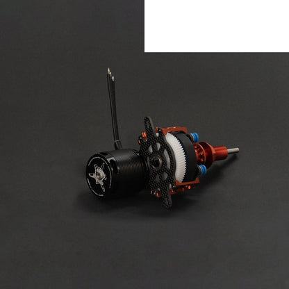 Contra drive motor and gearbox assembly lying on side, carbon plate and white gear visible