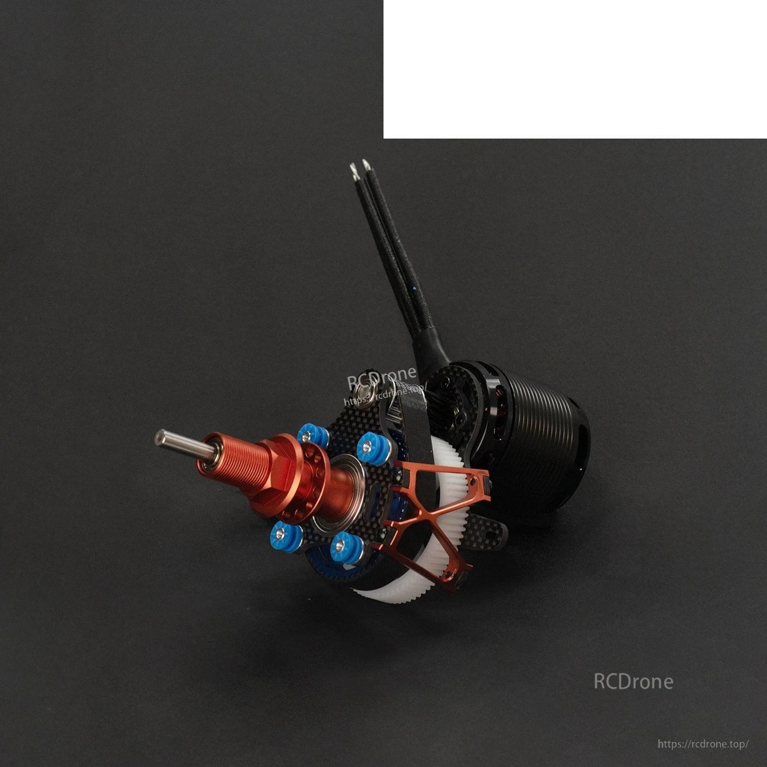 Angled view of contra drive showing red spinner hub, carbon bracing, and gear housing