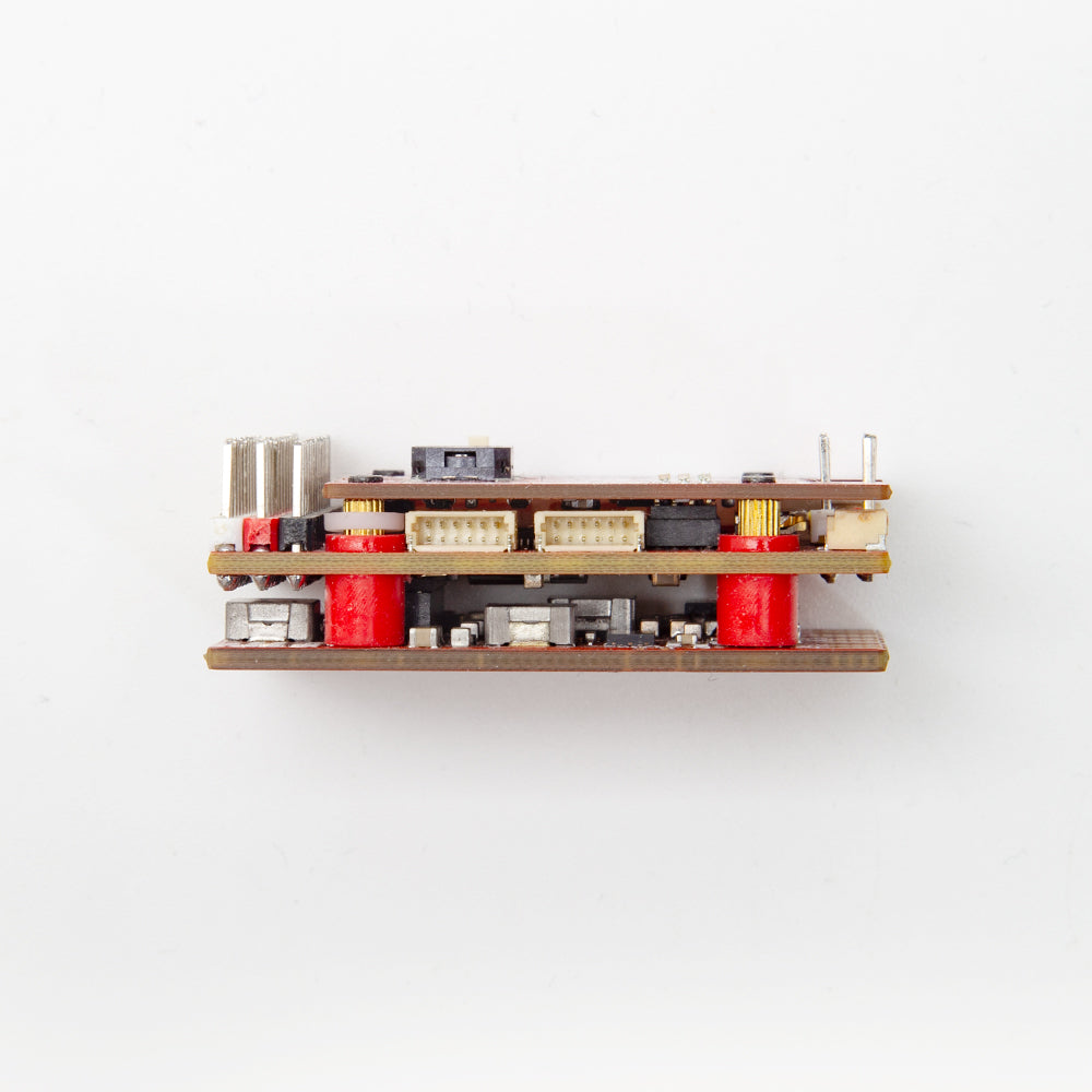 Side profile of flight controller stack showing board spacing, JST connector row, and pin headers