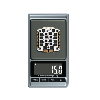 Flywoo GOKU G55M ESC board on digital scale reading 15.0g, with four mounting holes and edge solder pads